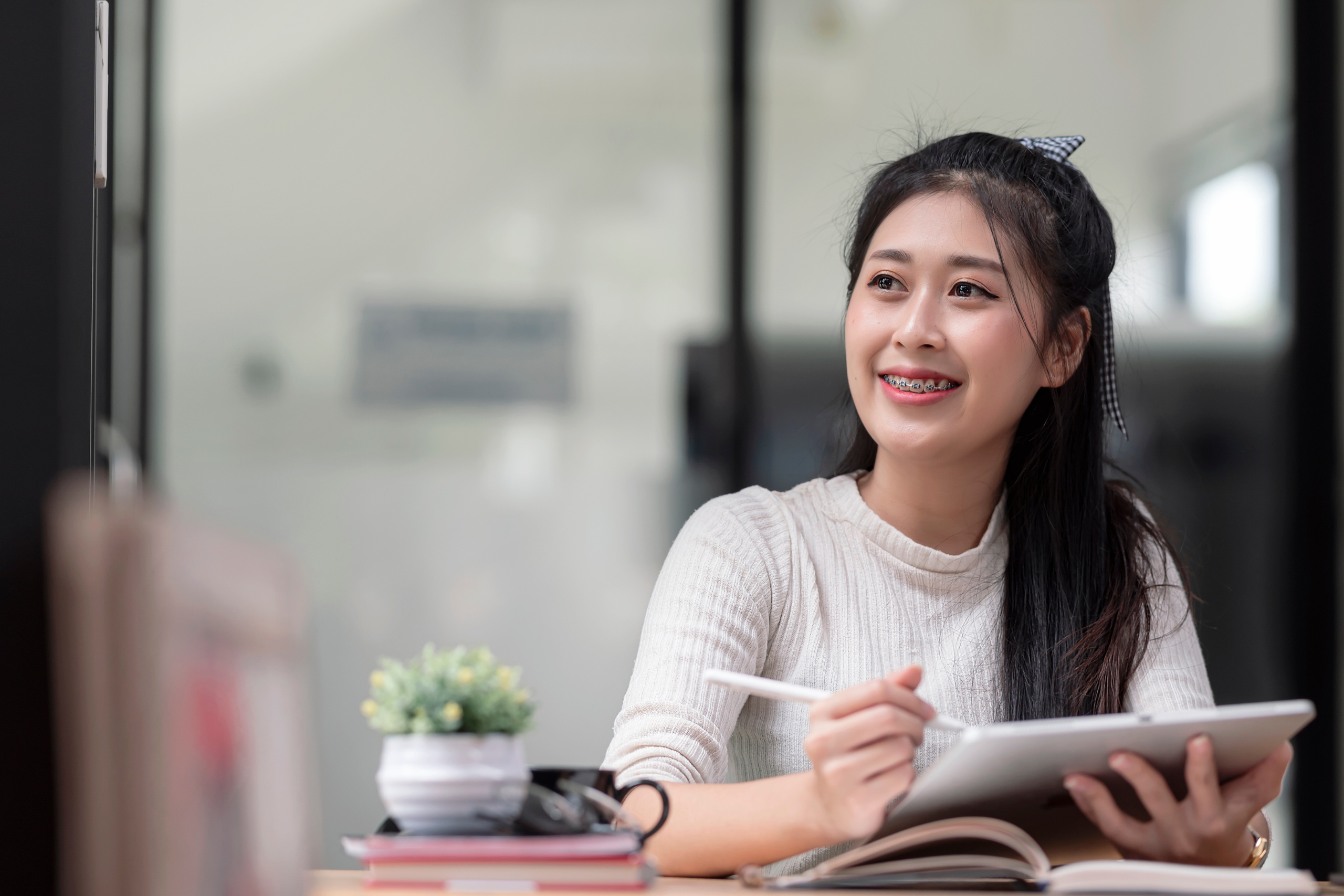 Woman smiling holding tablet