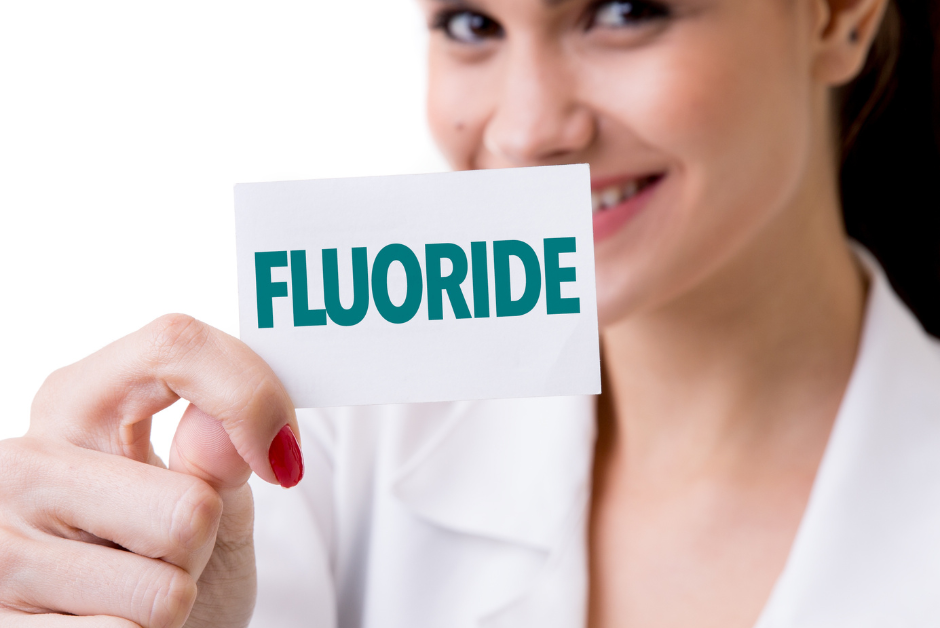 Lady holding a sign saying Fluoride