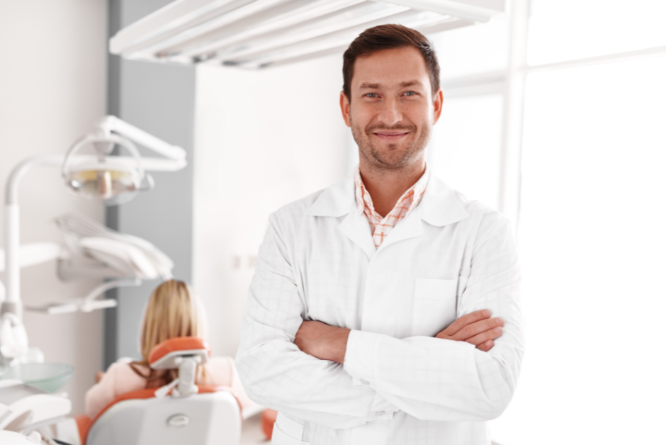 Dental professional in a white coat