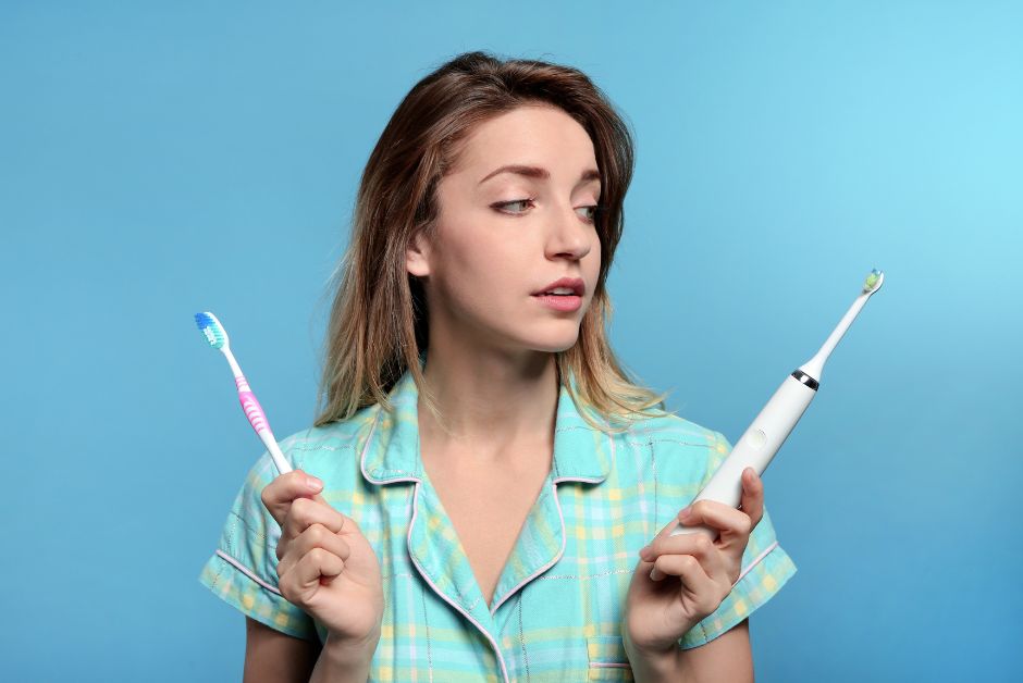 Lady holding toothbrushes